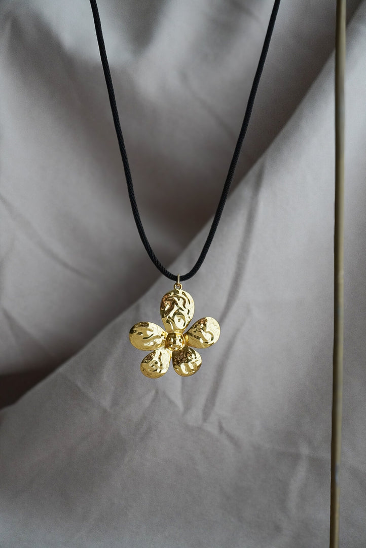 Collar cordón con flor de chapa de oro.